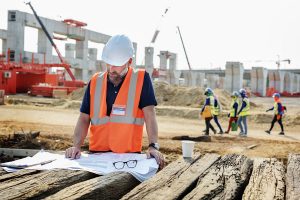 construction foreman looking at blueprints